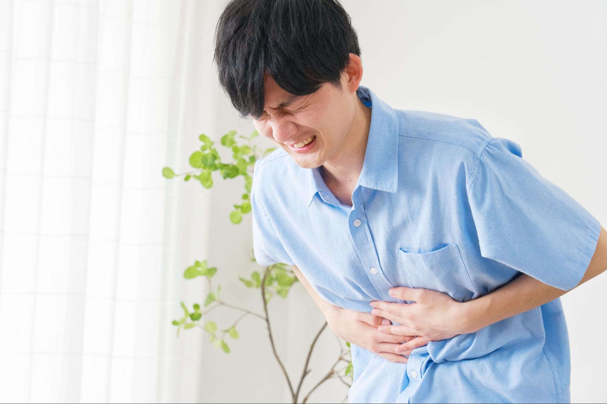腹痛に苦しむ様子の男性